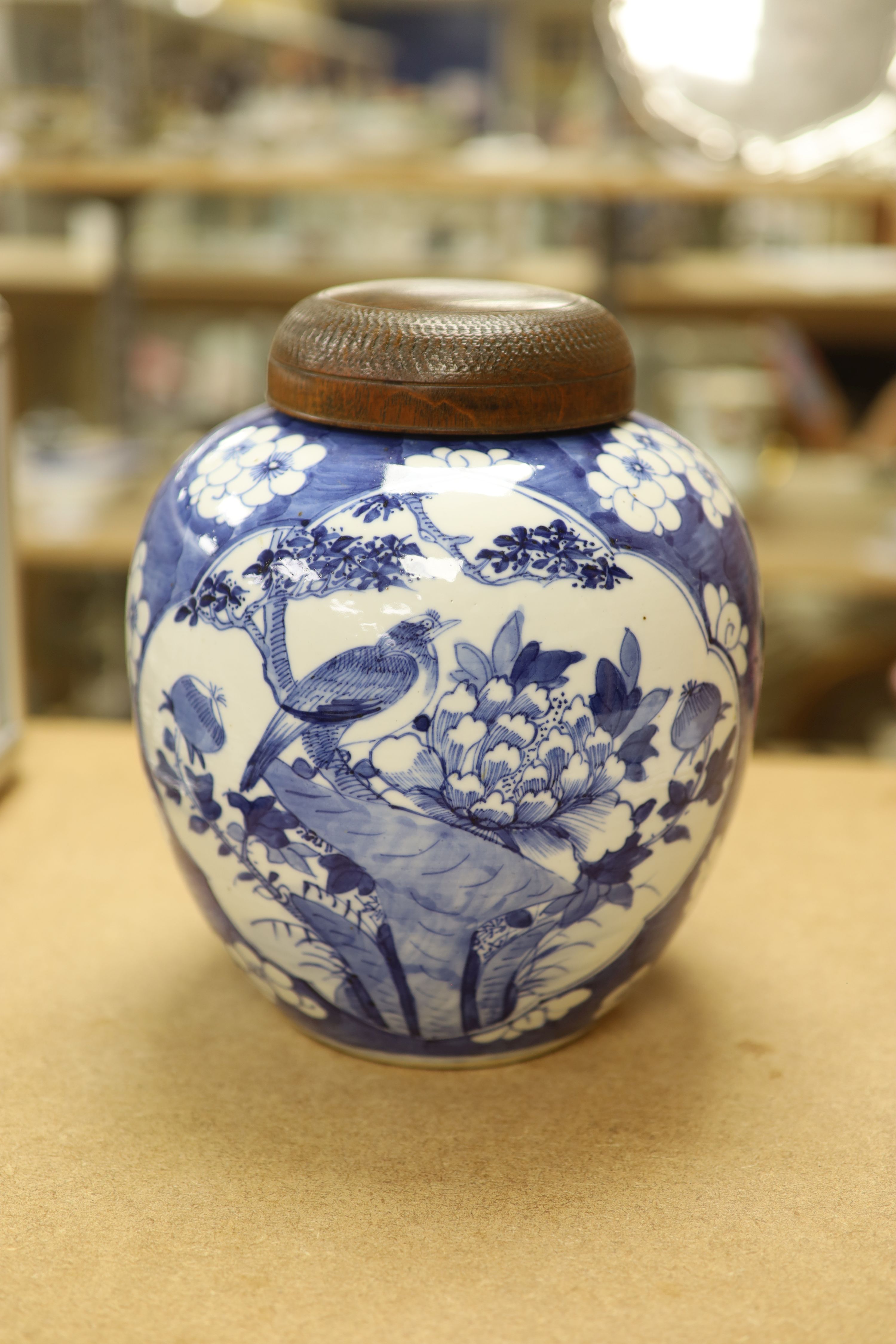 A late 19th / early 20th century Chinese blue and white jar, with wooden cover, height 25cm